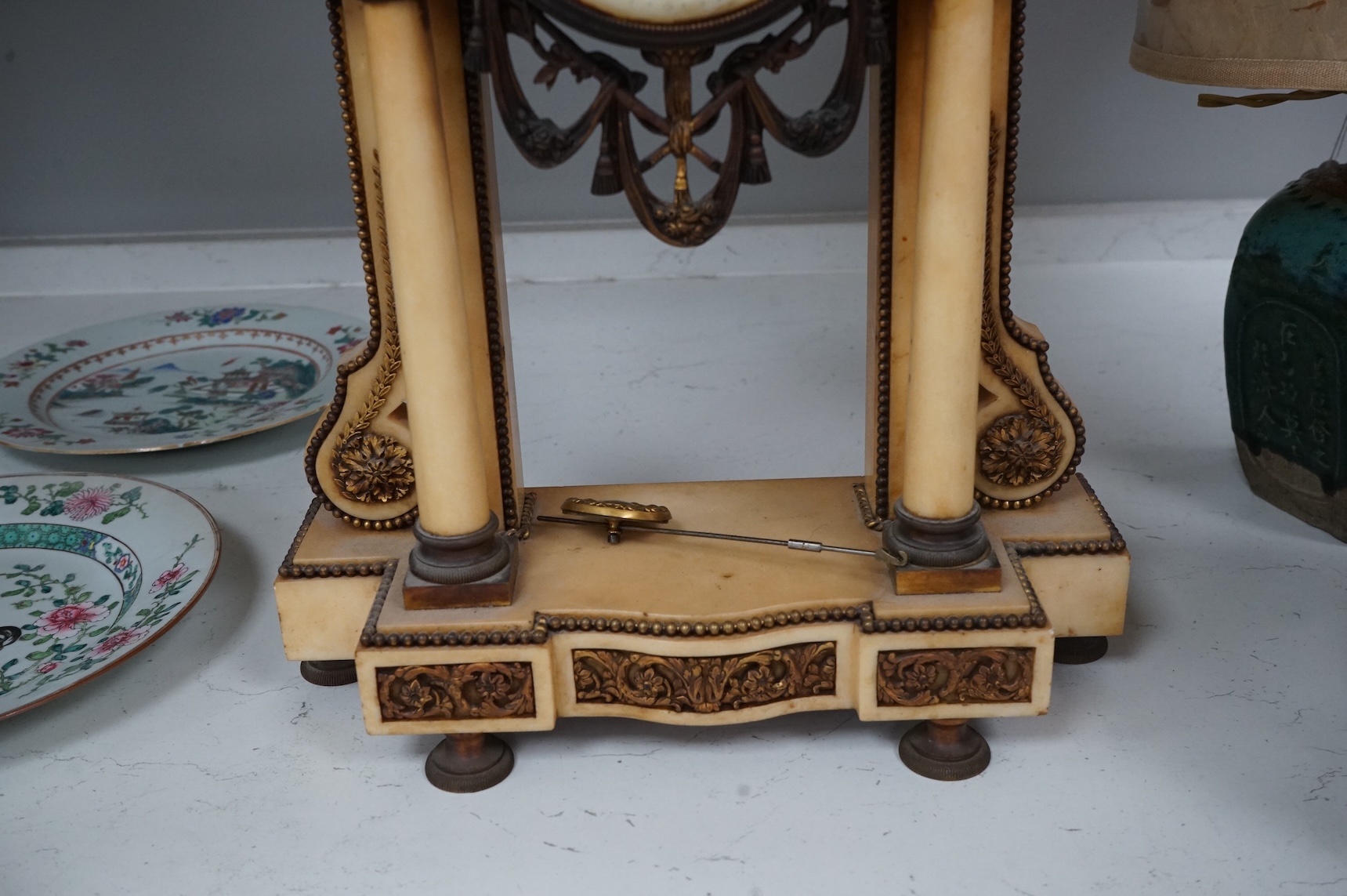 A French gilt metal and alabaster mantel clock, striking on a bell, with pendulum, 49cm high